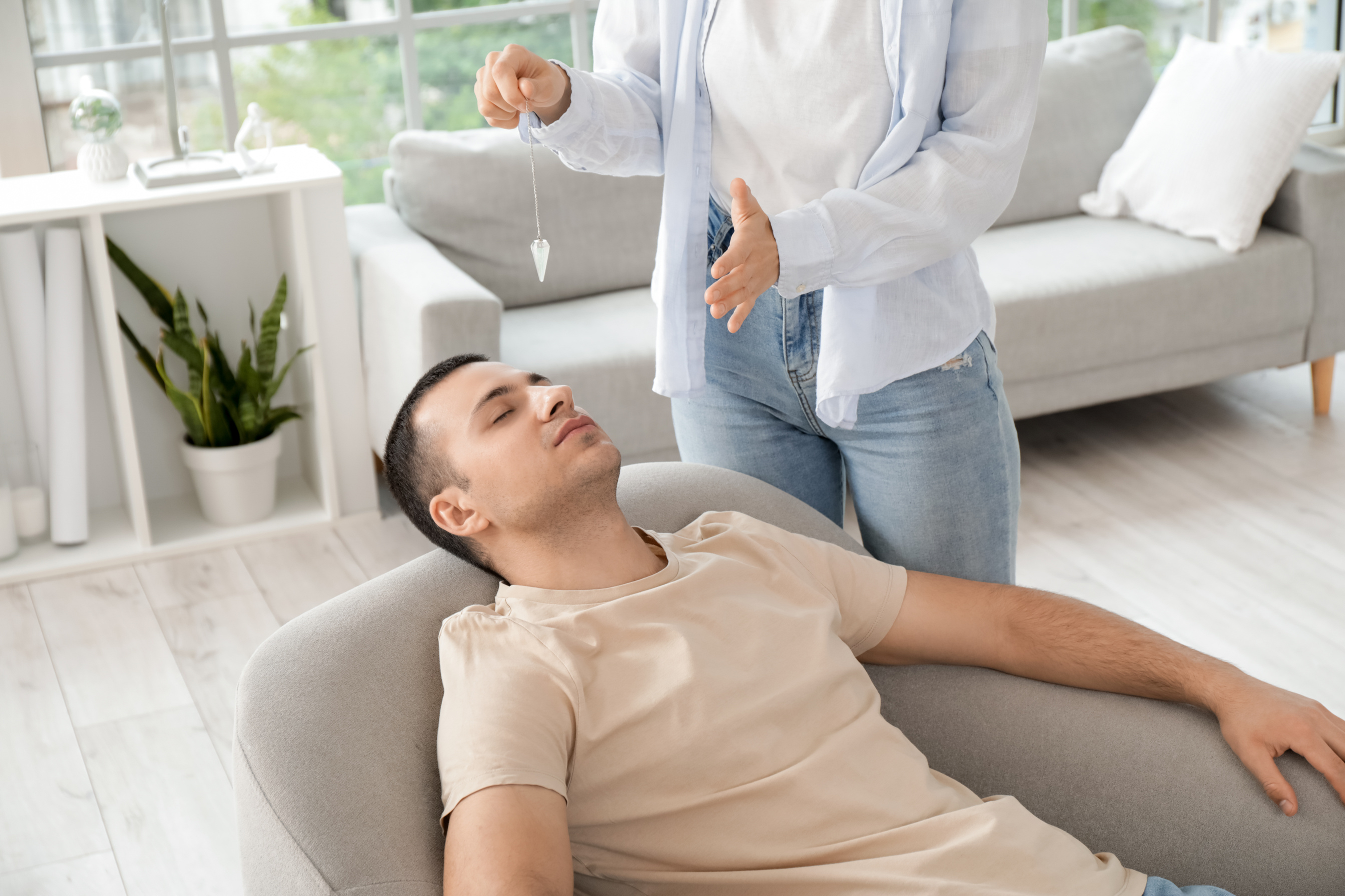 Young Man Lying in Armchair during Hypnosis Session at Psychologist's Office